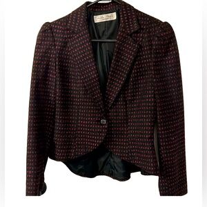 Cute short blazer with an asymmetrical look. Shorter in the front than the back.
